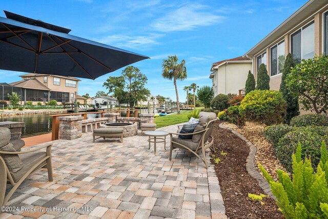 view of patio featuring a fire pit and a water view