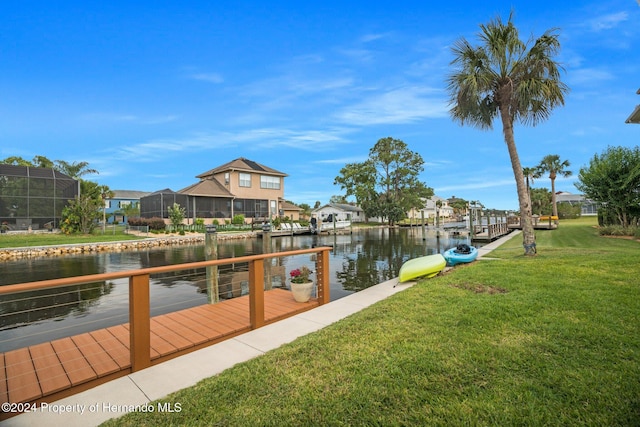 view of dock featuring a water view and a lawn