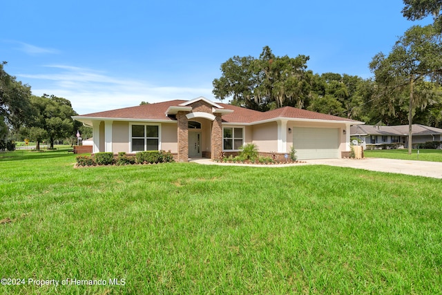 single story home featuring a garage and a front yard