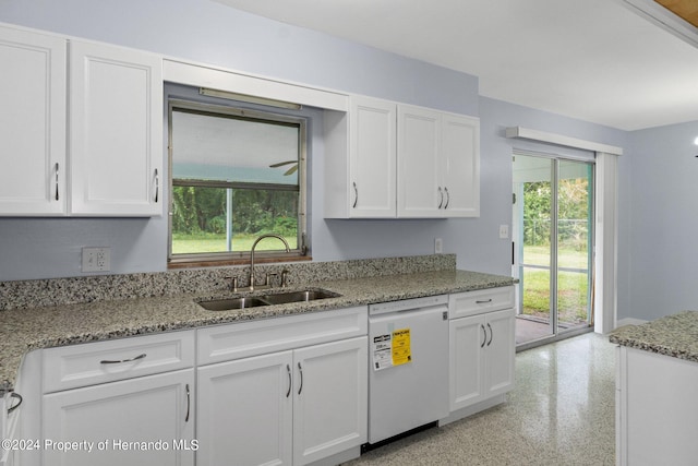 kitchen featuring white cabinets, sink, white dishwasher, and plenty of natural light