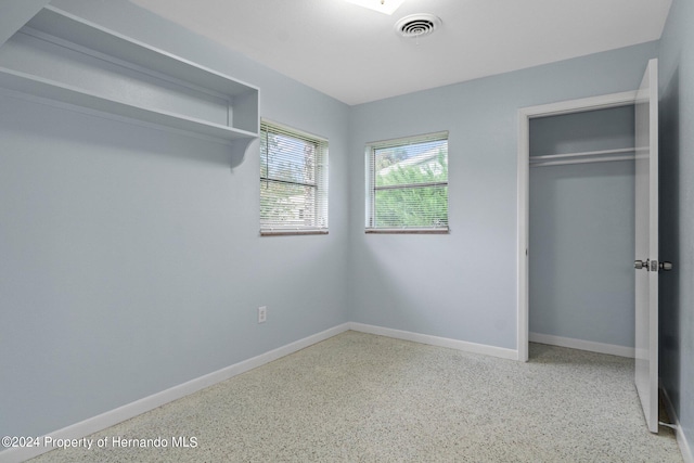 unfurnished bedroom featuring a closet