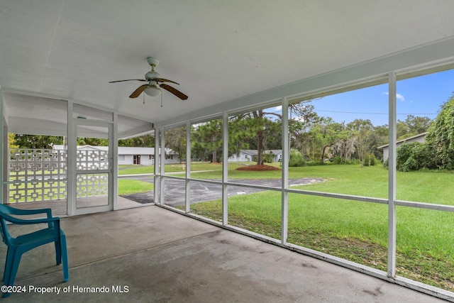 unfurnished sunroom featuring vaulted ceiling and ceiling fan