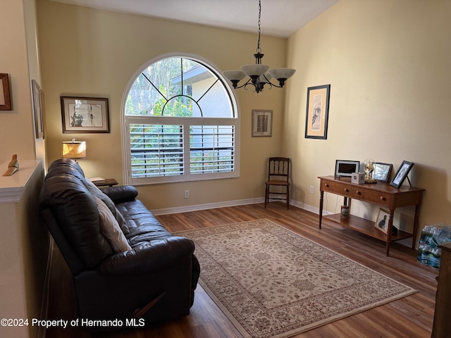 living room with hardwood / wood-style flooring and an inviting chandelier