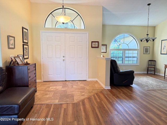 foyer featuring hardwood / wood-style floors and a chandelier