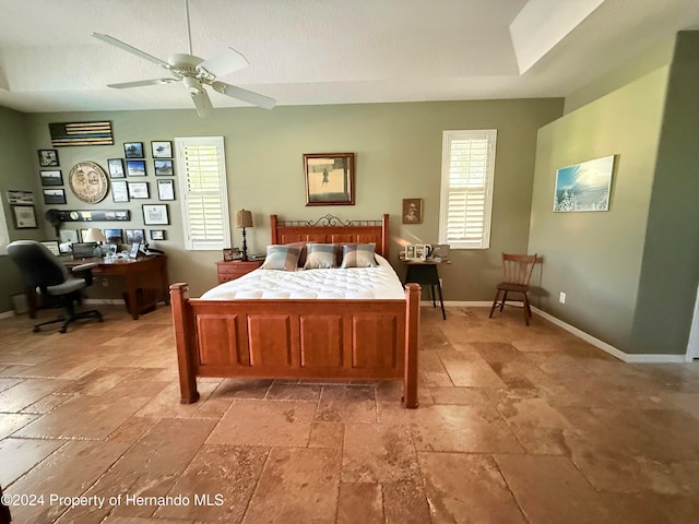 bedroom featuring a textured ceiling and ceiling fan