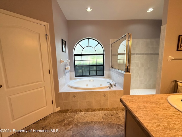 bathroom featuring vanity and separate shower and tub