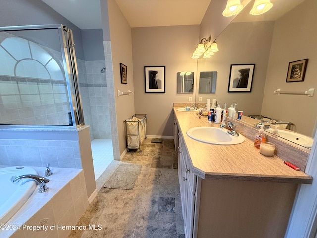 bathroom featuring vanity and independent shower and bath