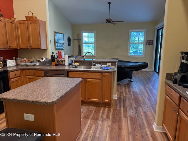 kitchen with dark wood-type flooring, sink, stainless steel dishwasher, ceiling fan, and a kitchen island