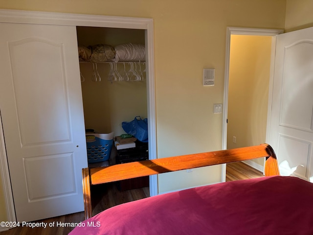 bedroom featuring hardwood / wood-style flooring and a closet