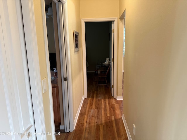 corridor with dark hardwood / wood-style flooring