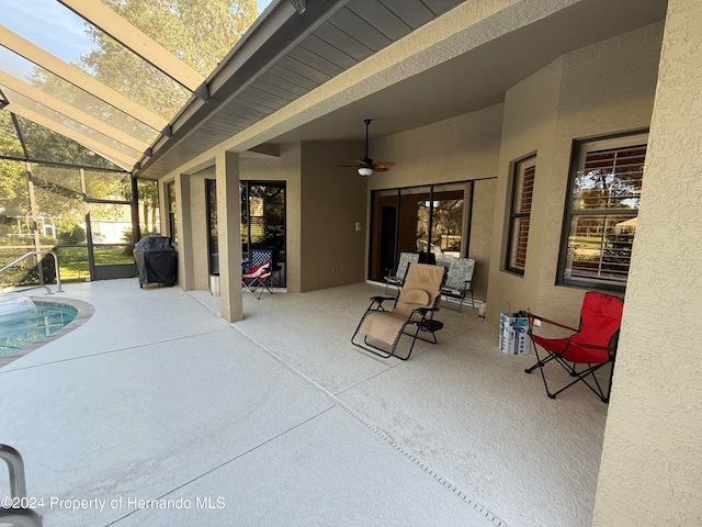 view of patio / terrace featuring area for grilling, a lanai, and ceiling fan