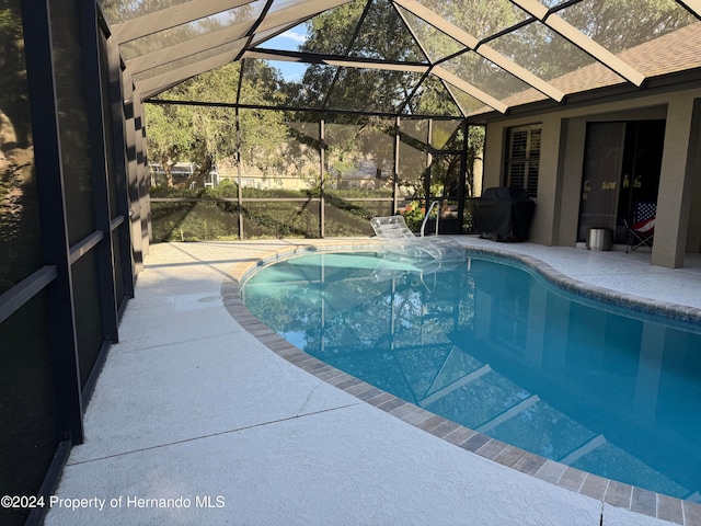 view of pool featuring a lanai and a patio