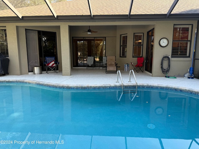 view of pool with a patio area, a lanai, and ceiling fan