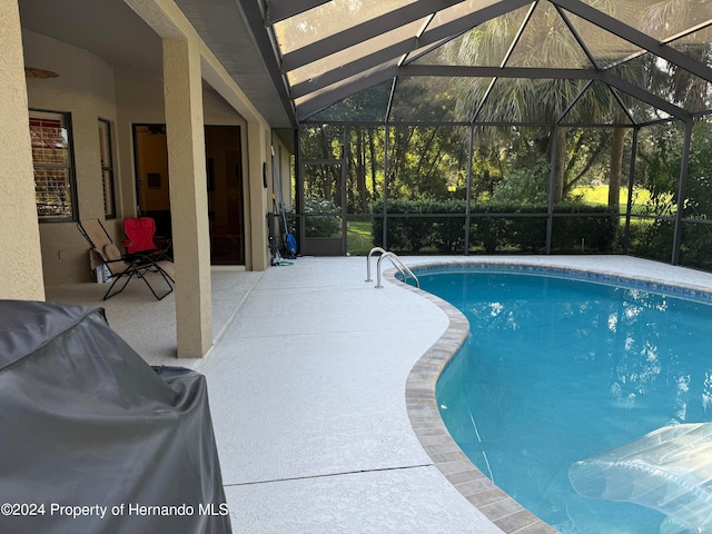 view of pool with a lanai and a patio