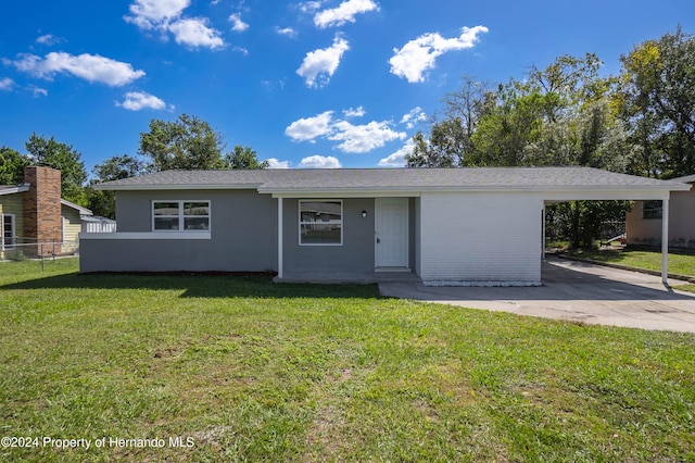 single story home featuring a carport and a front yard