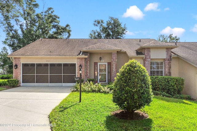 view of front of house with a front lawn and a garage