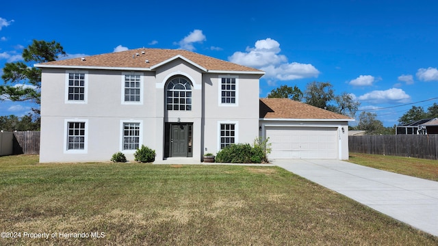 view of front of home featuring a garage and a front yard