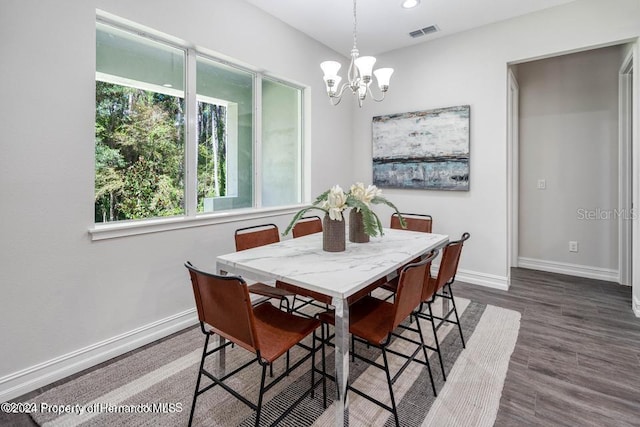 dining area with a chandelier and wood-type flooring