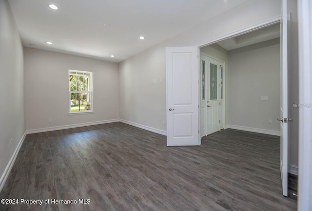 empty room featuring dark wood-type flooring