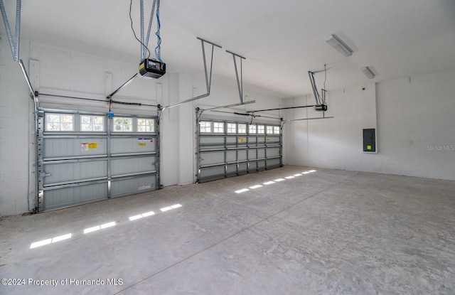 garage featuring electric panel and a garage door opener