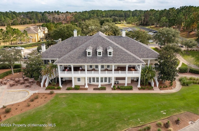 6436 Summit View Dr, Brooksville, FL 34601 - rear view of property with a chimney, a shingled roof, a patio, and a lawn