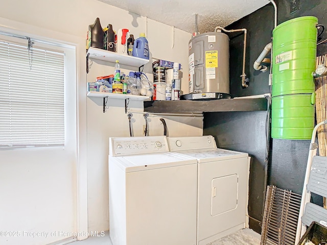 laundry room with washer and dryer, a textured ceiling, and water heater