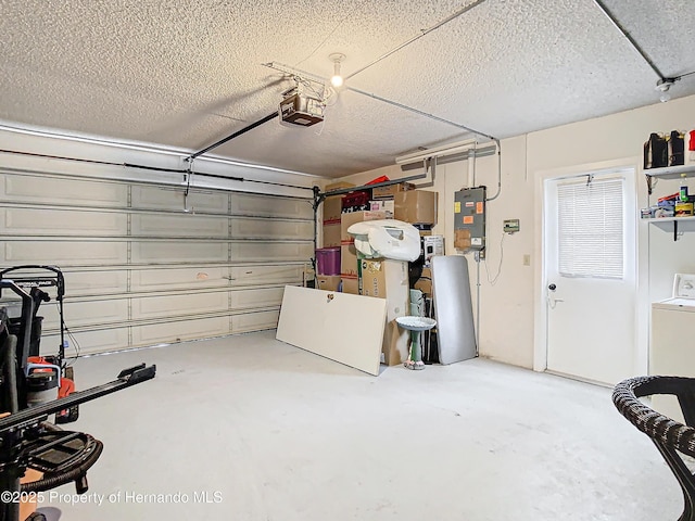 garage with electric panel, a garage door opener, and washer / dryer