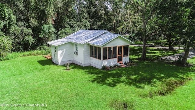 exterior space with a sunroom and a yard