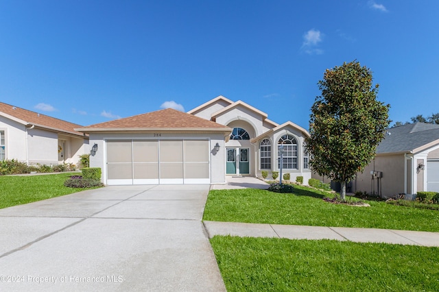 ranch-style home featuring a garage and a front yard