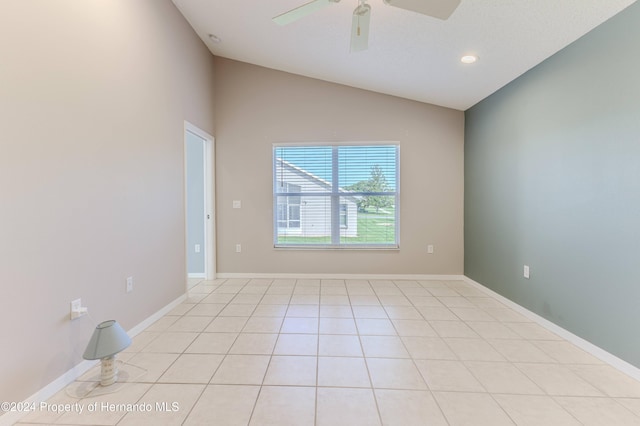 tiled empty room featuring ceiling fan and lofted ceiling