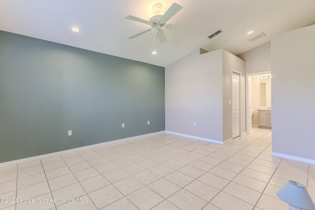 tiled spare room with ceiling fan and lofted ceiling