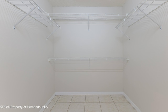 walk in closet featuring light tile patterned floors