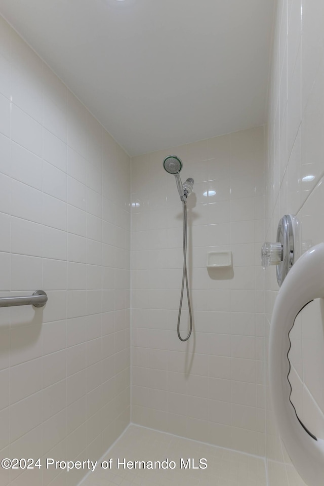 bathroom with a tile shower