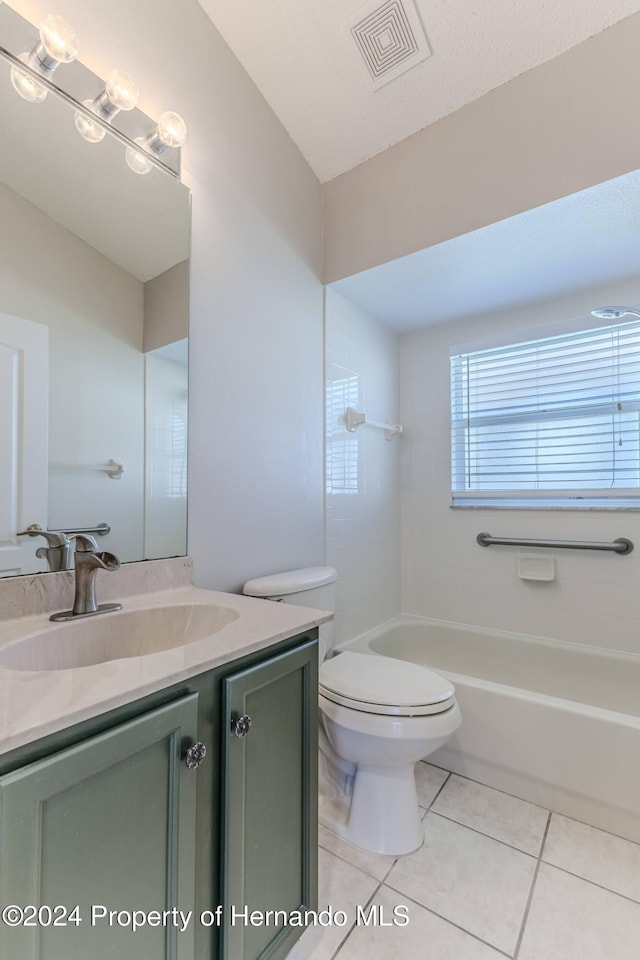 full bathroom featuring tile patterned flooring, vanity, toilet, and tiled shower / bath