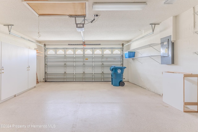 garage with electric panel and a garage door opener