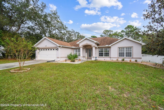 ranch-style house with a front yard and a garage