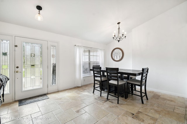 dining area featuring plenty of natural light, a chandelier, and lofted ceiling