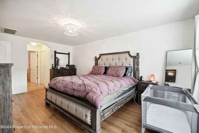 bedroom with hardwood / wood-style floors