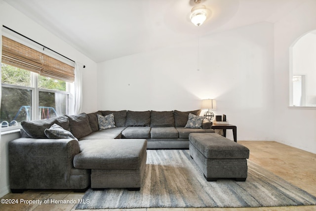 living room with ceiling fan and vaulted ceiling