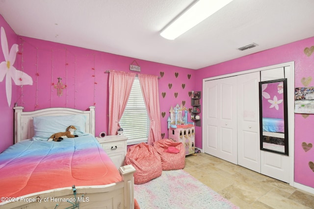 bedroom featuring a closet and a textured ceiling