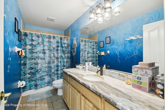 bathroom with tile patterned flooring, vanity, and toilet