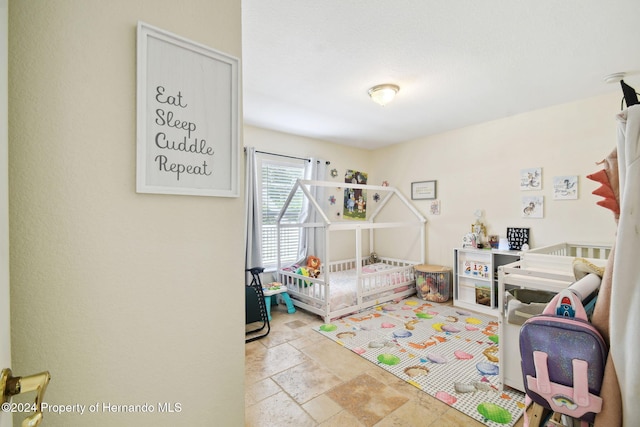 bedroom featuring a crib