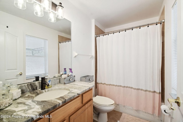 full bathroom featuring tile patterned flooring, vanity, shower / bath combination with curtain, and toilet