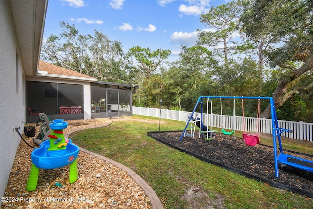 view of yard with a playground and a sunroom