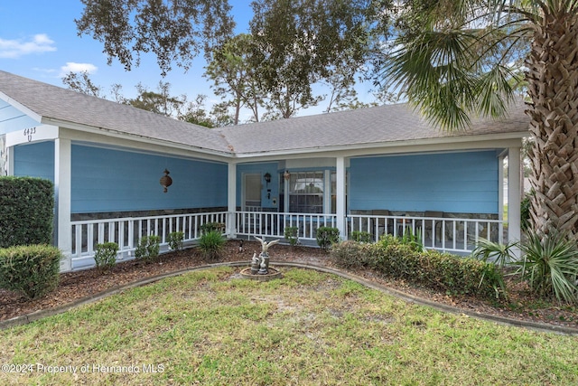 view of front facade featuring a front lawn and covered porch