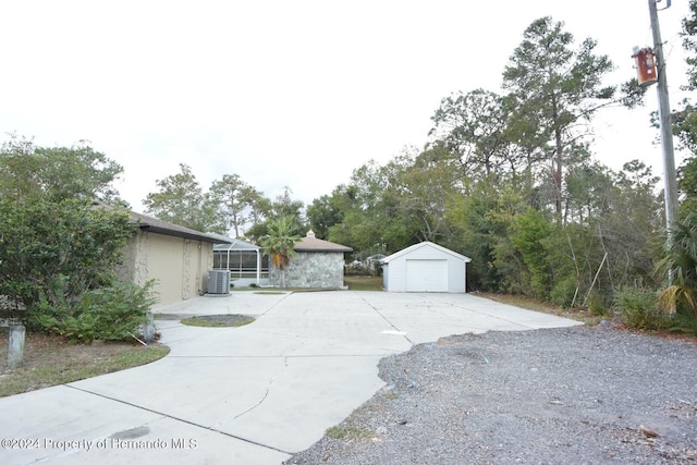 view of property exterior featuring central AC unit and an outdoor structure