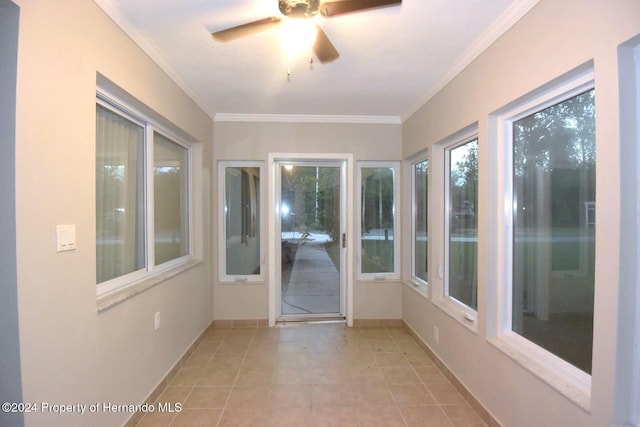 unfurnished sunroom featuring ceiling fan