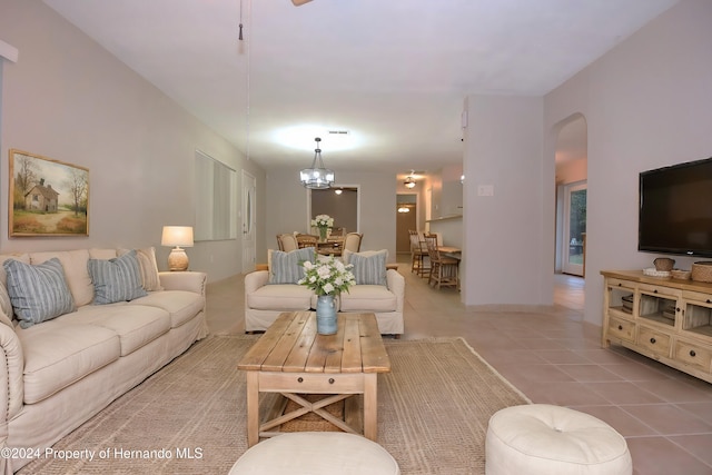 living room featuring tile patterned floors and a chandelier