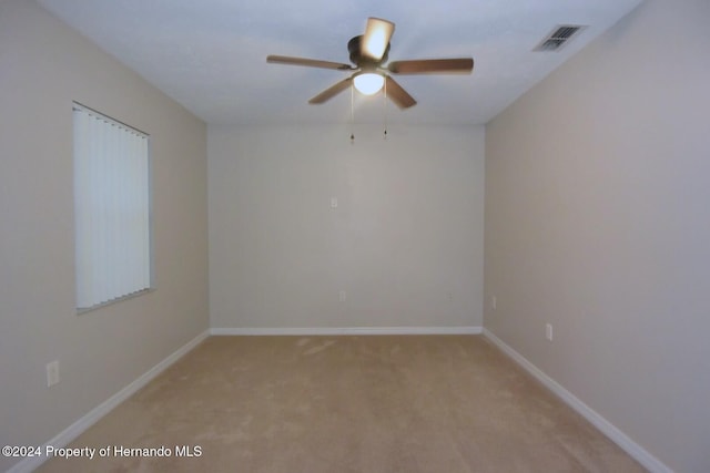 unfurnished room with ceiling fan and light colored carpet