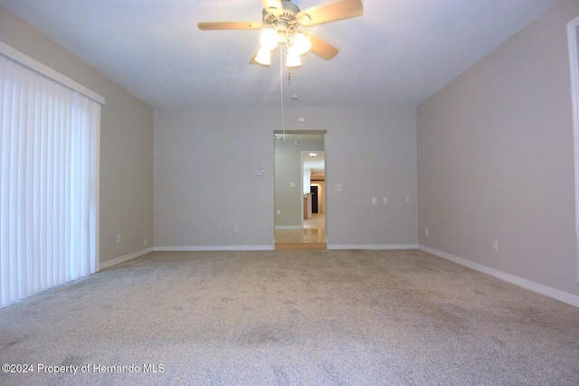 carpeted empty room featuring ceiling fan